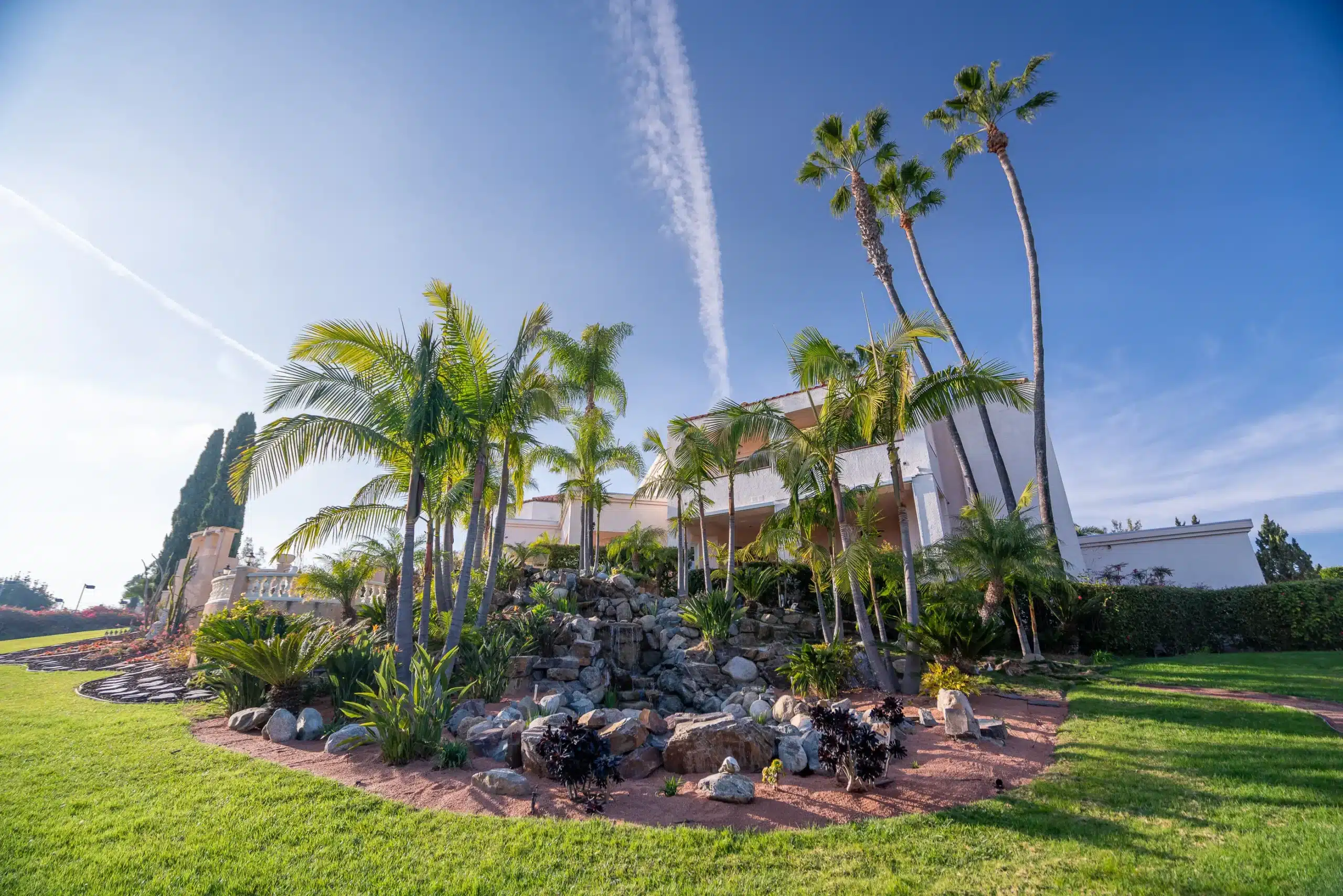 The front of our Villa Oasis rehabilitation center. There are many palm trees and flowers