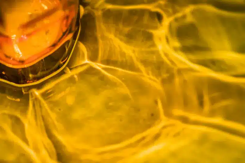 A shot from the inside of a glass full of yellow alcohol