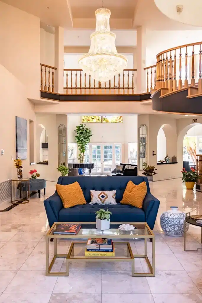 Villa Oasis living room with a blue couch and a beautiful chandelier hanging from the ceiling