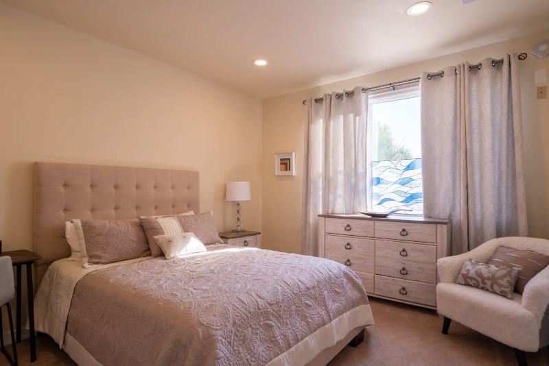 suite in Villa Oasis' residential rehab center in San Diego featuring a king size bed and furniture