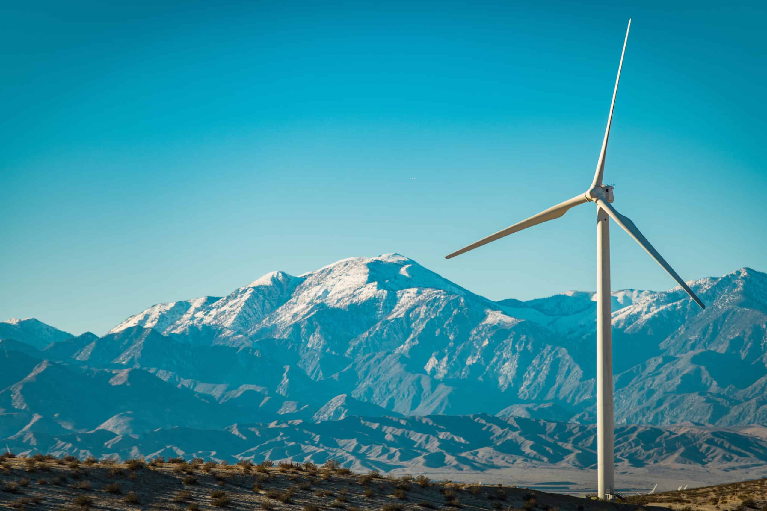 Wind Energy Plant Turbine and San Bernardino Mountains Covered by Snow, California USA. Green Energy Supply Theme.