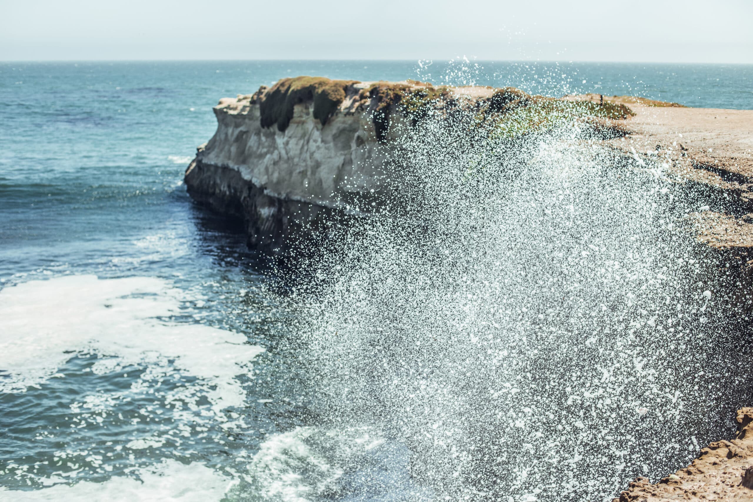 Sea surges with splashes near rocks of†shore in sunny day in San†Francisco, USA