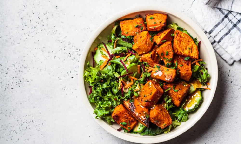 Baked sweet potato salad with cucumbers and lettuce