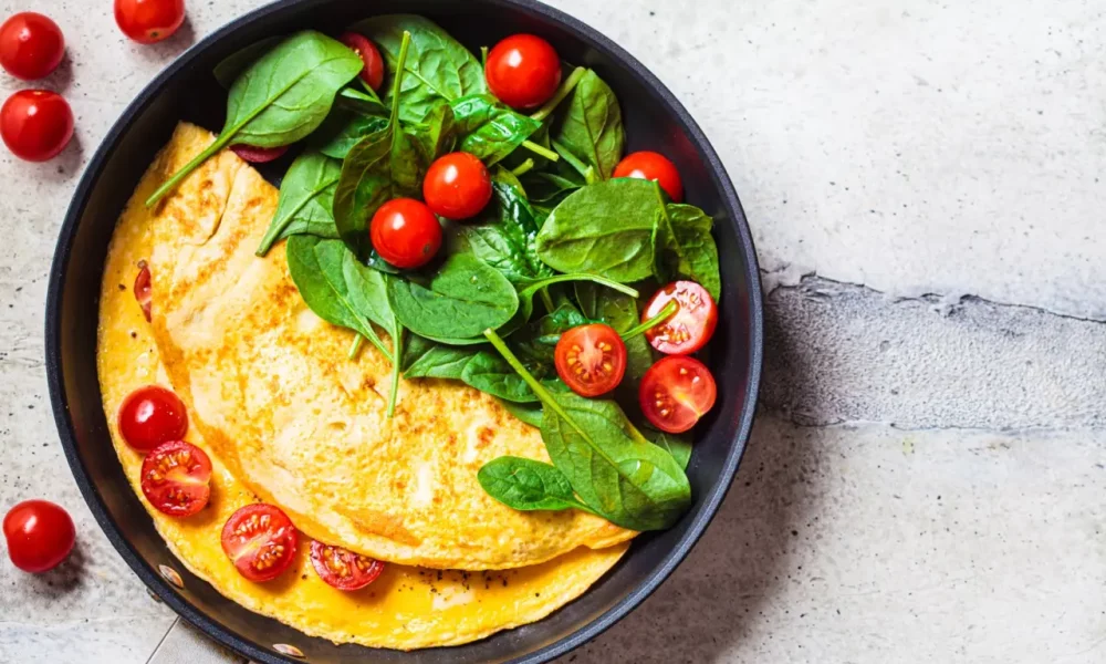 Omelet with fresh spinach and cherry tomatoes