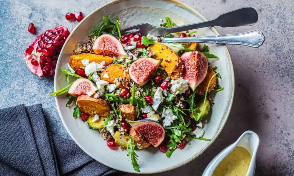 Quinoa salad with baked vegetables, cheese, and figs